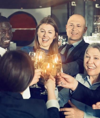 People toasting with glasses at a corporate event